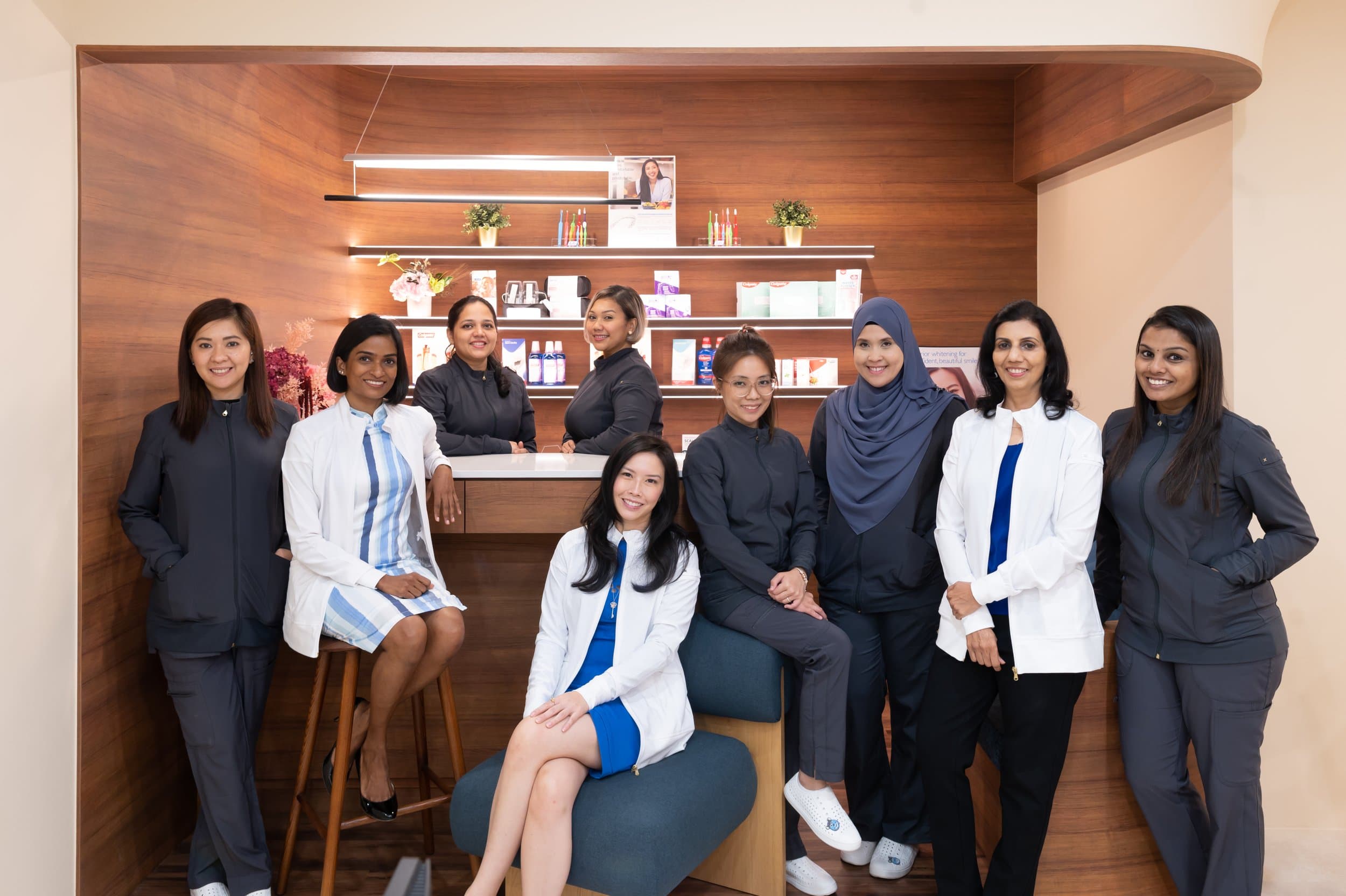 The wider Align Dental Surgery team of dentists and clinical staff at the clinic reception, Forum The Shopping Mall, Orchard Road, Singapore